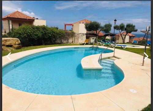 a swimming pool with a bench in the middle at Luxury town House with private garden in Duquesa in San Luis de Sabinillas