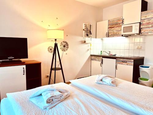 a room with a bed with towels on it at Appartementhaus Sonnenschein in Binz