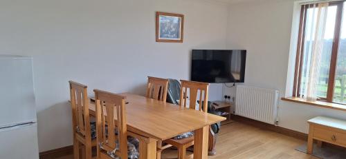 a dining room with a wooden table and chairs at 2 Bed Cottage - sleeps 4 - Garden Parking Wifi in Swansea