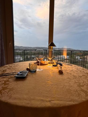 a table with wine glasses and a view at Casa dello Yoga Suite e Private Spa in Colonnella