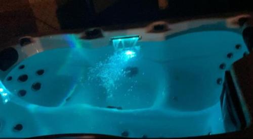 a bath tub with a blue light in it at Casa dello Yoga Suite e Private Spa in Colonnella
