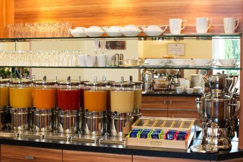 a bar with a bunch of different colored drinks at Hotel Panorama in Heidelberg