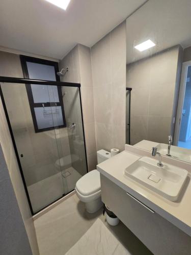 a bathroom with a toilet and a sink and a shower at Cais Eco Residencia Boutique Beira Mar in Porto De Galinhas