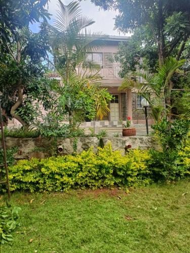 a house with trees and plants in front of it at Bonkate homes in Ongata Rongai 