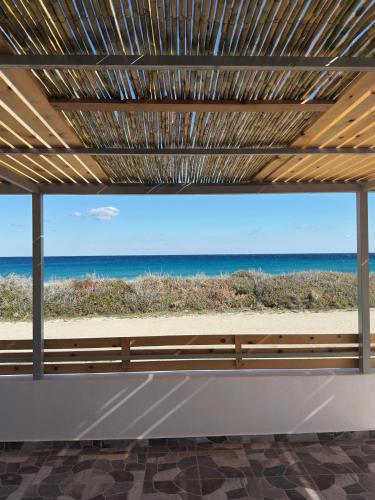 a window with a view of the beach at Villa Del Mare in Karpathos Town