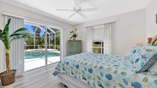 a bedroom with a bed and a swimming pool at RTC974 in Rotonda West