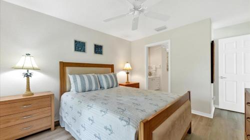 a bedroom with a bed and a ceiling fan at RTC974 in Rotonda West