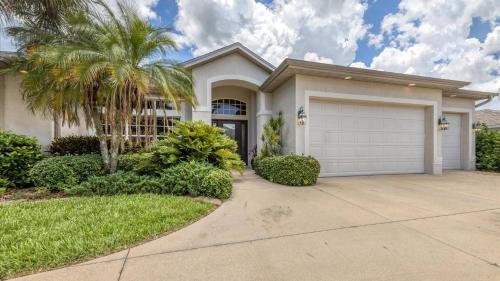 a house with a palm tree and a garage at RTC974 in Rotonda West
