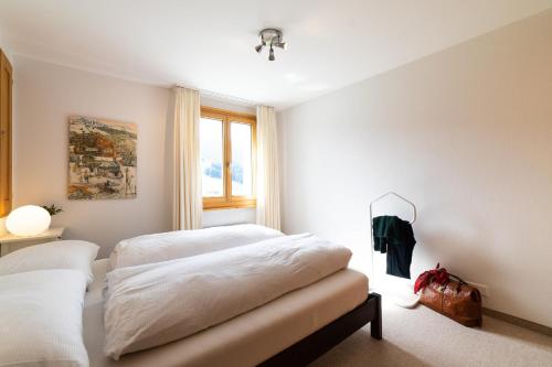 a bedroom with two beds and a window at Steinrüti in Wildhaus
