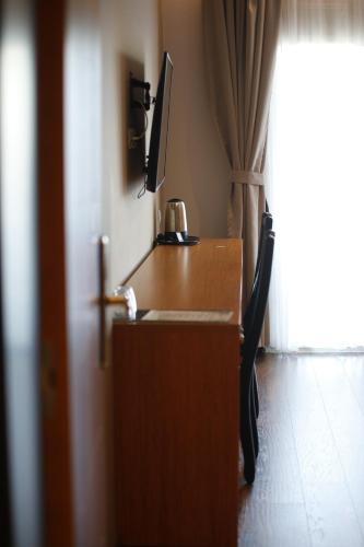 a desk with a coffee pot on top of it at Olivia's Hill Resort in Durrës