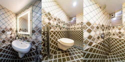 a bathroom with a toilet and a sink at Treebo Grand Royale Eco Residency in Cavelossim