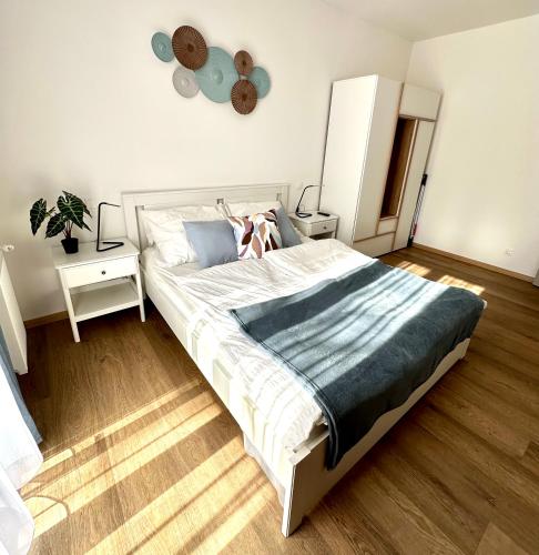 a bedroom with a large bed with a woman on it at Falcon Apartman Tatabánya in Tatabánya