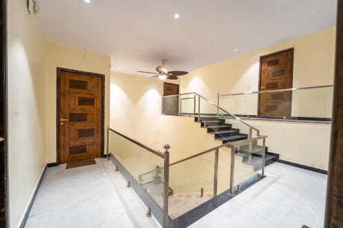 a staircase in a house with a ceiling fan at Treebo Grand Royale Eco Residency in Cavelossim