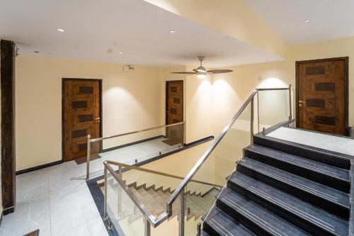 a staircase in a house with a ceiling fan at Treebo Grand Royale Eco Residency in Cavelossim