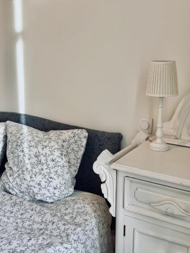 a bed with a pillow and a lamp next to a table at Peaceful retreat in Drome Provencale Castel in Montboucher-sur-Jabron