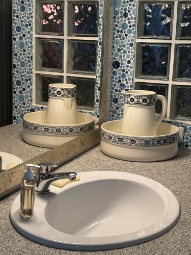 a bathroom counter with a sink and a mirror at Corte Arancio your home in the heart of Monferrato in Cella Monte