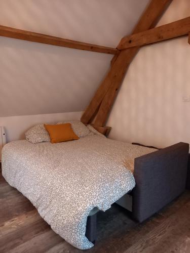 a bedroom with a bed in a attic at A l'Ombre du Laurier in Monchy-au-Bois