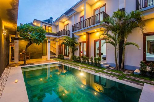 a house with a swimming pool in front of it at Room Valka Bali Seminyak in Seminyak