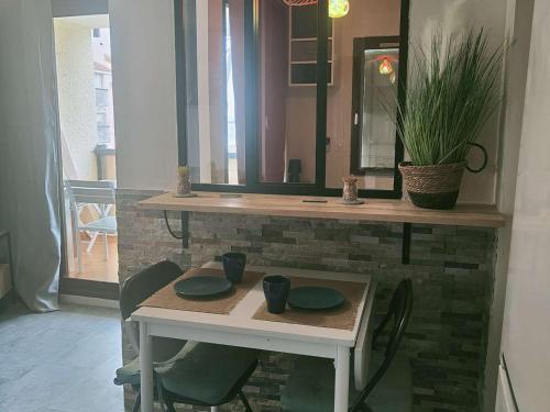 une table avec deux tasses vertes en haut dans l'établissement Studio cabine climatisé avec wifi, piscine et parking à Coudalère - FR-1-195-112, au Barcarès