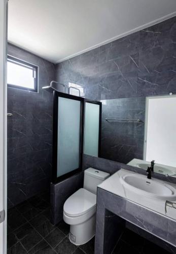 a bathroom with a toilet and a sink at Sea & Sand House in Ban Khlong Khut