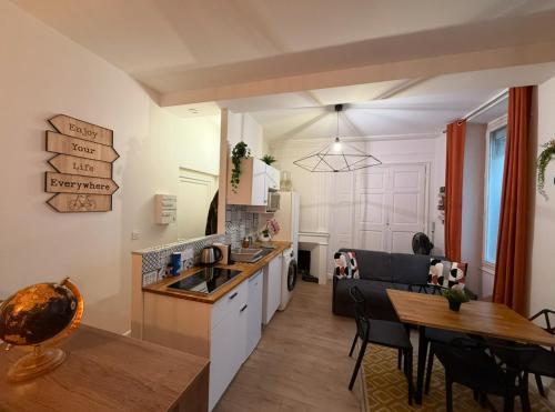 a kitchen and dining room with a table and a dining room at Les Studios du Centre Historique de Valence in Valence