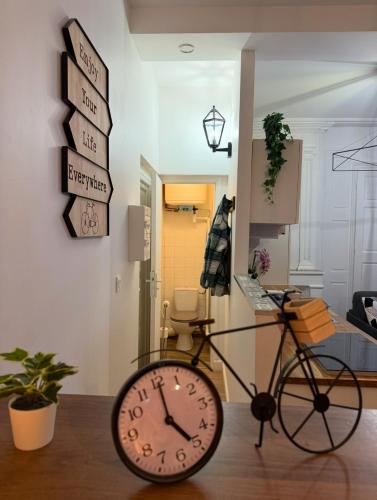 a bike in a room with a clock on the floor at Les Studios du Centre Historique de Valence in Valence