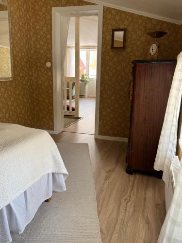 Un dormitorio con una cama y una puerta a un pasillo. en Gamla Ersgården i Ersmark Umeå, en Umeå