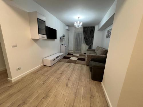 a living room with a couch and a tv at Abel 27 Residence in Bacău