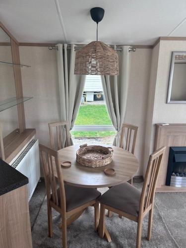 a table and chairs in a kitchen with a window at 151 Newquay Bay Resort in Newquay Bay Resort