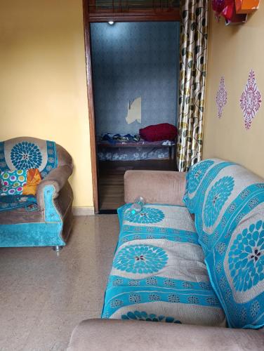 a living room with two couches and a mirror at Uma bhavan in Prayagraj