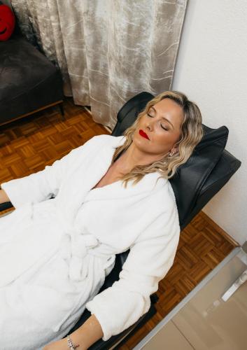 a woman laying in a chair in a room at DolceVita in Vinkovci