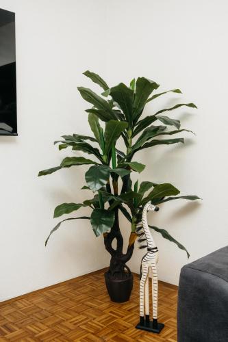 a skeleton standing next to a plant in a room at DolceVita in Vinkovci