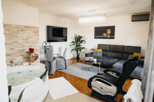 a living room with a bath tub and a couch at DolceVita in Vinkovci