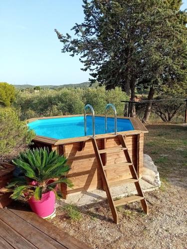 une piscine avec une terrasse en bois et une piscine dans l'établissement La Maisonnette de Saint-Julien, à Martigues