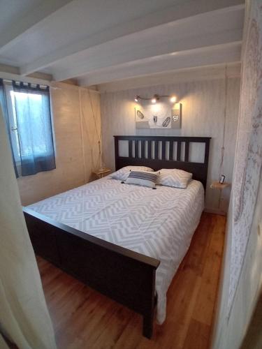 une chambre avec un grand lit avec des draps blancs dans l'établissement La Maisonnette de Saint-Julien, à Martigues