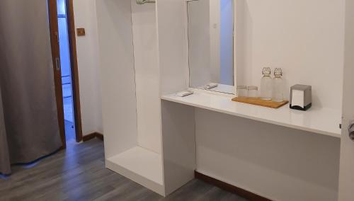 a bathroom with a counter with two bottles and a mirror at Island Grand Maldives in Hangnaameedhoo