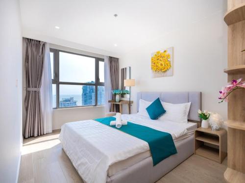 a bedroom with a large bed and a window at Cloud Nine The Song Vung Tau Homestay in Vung Tau