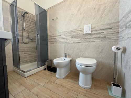 a bathroom with a toilet and a shower and a sink at Incanto in Sestu