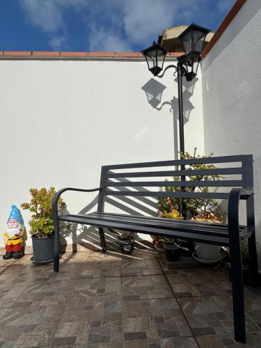 a bench sitting next to a wall with plants at Incanto in Sestu