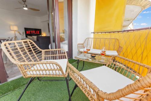2 chaises en osier et une table sur un balcon dans l'établissement Le Chambord - Hypercentre - Spacious - Terrace, au Cannet