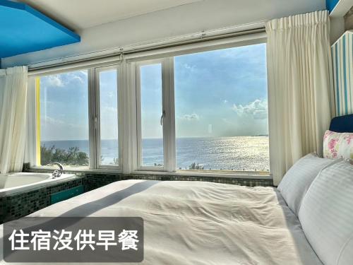 Postel nebo postele na pokoji v ubytování 南灣飯店 Kenting Nanwan Hotel