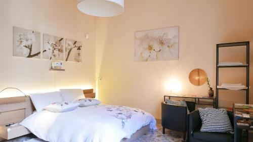 a bedroom with a bed and a desk and a chair at Three Rooms in Messina