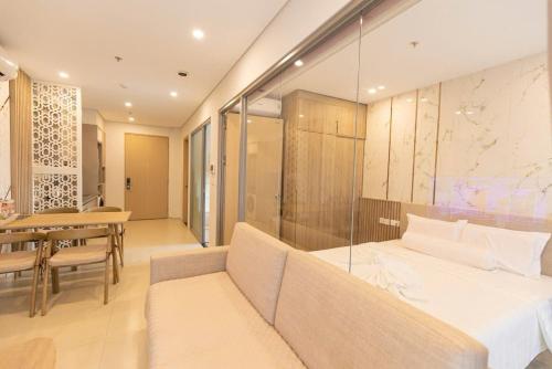a hotel room with a bed and a dining table at Cloud Nine The Song Vung Tau Homestay in Vung Tau