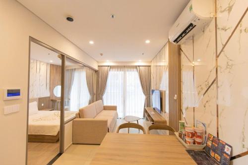 a living room with a couch and a bedroom at Cloud Nine The Song Vung Tau Homestay in Vung Tau