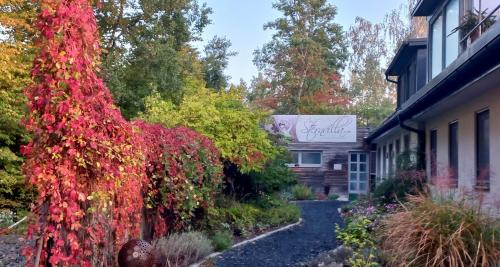 a house with red leaves on the side of it at Sternvilla - Traumhaftes Apartment in bester Lage in Bad Tatzmannsdorf