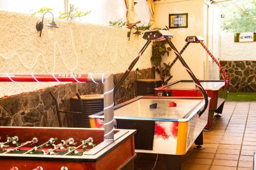a lamp in a room with a ping pong table at Hostal Playa Candor in Rota