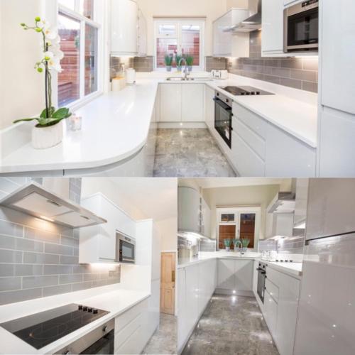 a kitchen with white cabinets and a sink at The Haven in York