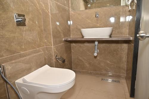 a bathroom with a toilet and a sink at Galaxy Stays BKC in Mumbai