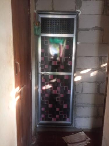 a window in a room with a tile wall at Narayan Niwas in Vengurla