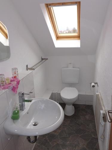 a bathroom with a white sink and a toilet at Haus Oberkassel in Bonn